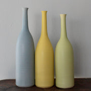 three ceramic bottles by Lucy Burley, blue, yellow and green