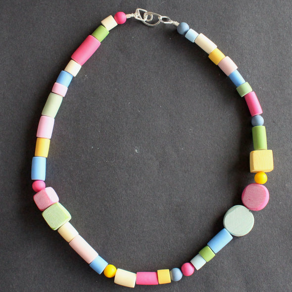 a necklace of different shaped beads in primary colours made by UK jewellery designer Clare Lloyd.