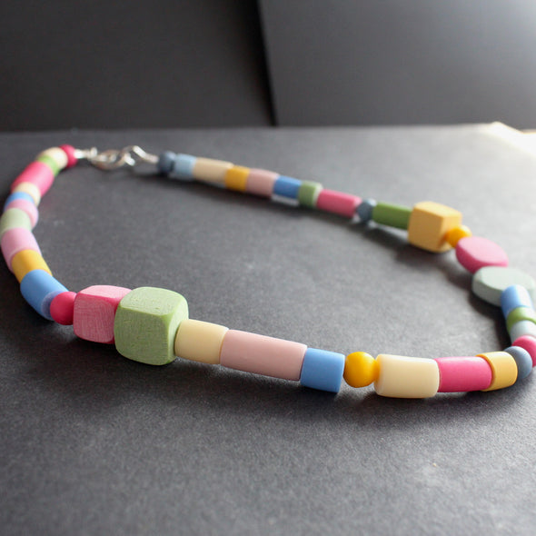necklace of different shaped beads in primary colours made by UK jewellery designer Clare Lloyd