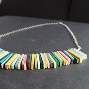 close up of a necklace in pinks, yellow and green oblong beads by jeweller Clare Lloyd.
