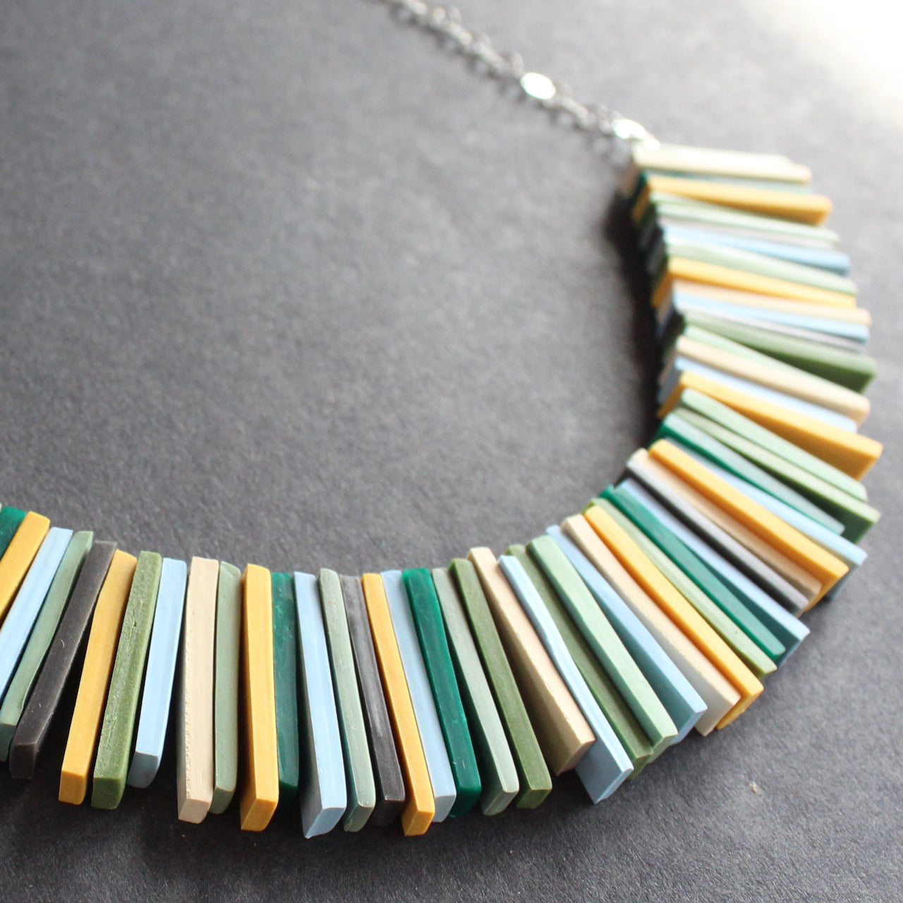 Modern deco necklace with greens, yellows and blues by Clare Lloyd
