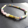 a necklace of pastel coloured random shaped beads by jewellery designer Clare Lloyd.