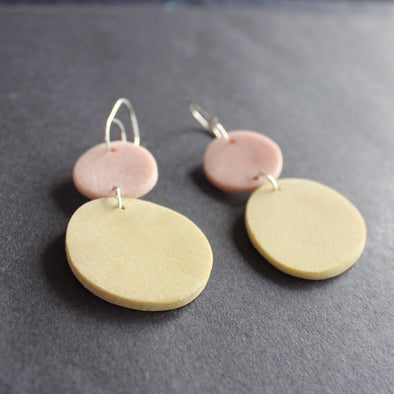 drop earrings of a large yellow disc with a smaller pale pink on a silver fixing by Clare Lloyd, UK based jewellery designer