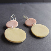 drop earrings of a large yellow disc with a smaller pale pink on a silver fixing by Clare Lloyd, Somerset based jeweller.