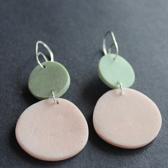Clare Lloyd misshaped drop earrings of a pink disc and smaller mint disc