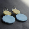 earrings made by UK jewellery designer Clare Lloyd of blue disc and smaller yellow disc