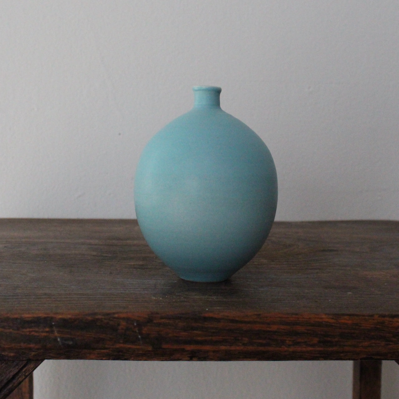 a turquoise round vase by UK ceramic artist Lucy Burley.