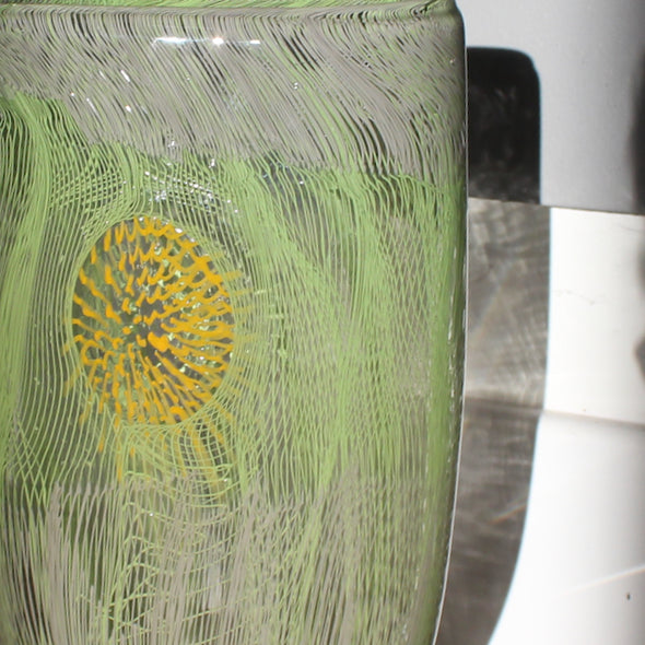 Close up of tall glass vessel in green by Benjamin Lintell