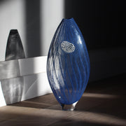 Glass vessel in dark blue waves by Benjamin Lintell