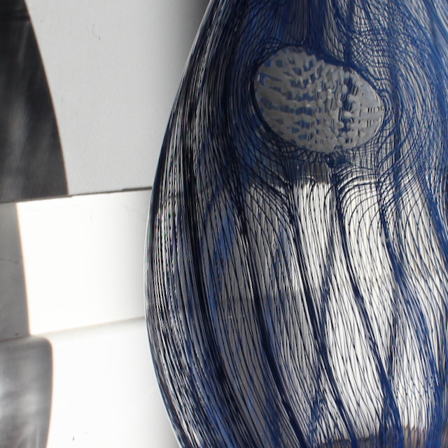Detail of glass vessel in dark blue waves by Benjamin Lintell