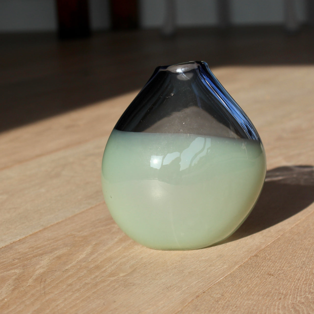 glass artist Michele Oberdieck's small teardrop shaped glass vessel in dark blue and pale green.