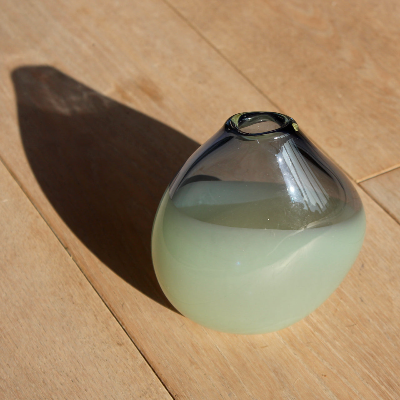 glass artist Michele Oberdieck's small teardrop shaped glass vessel in dark blue and pale green