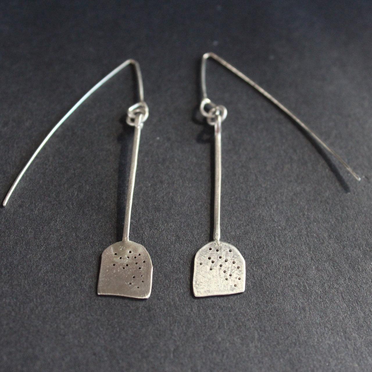 a pair of silver paddle shaped earrings by jewellery lizzie weir of Anatole Design.