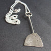 paddle shaped silver pendant on a silver chain by UK jeweller Lizzie Weir of Anatole Design