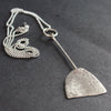 a paddle shaped silver pendant on a silver chain by UK jeweller Lizzie Weir of Anatole Design