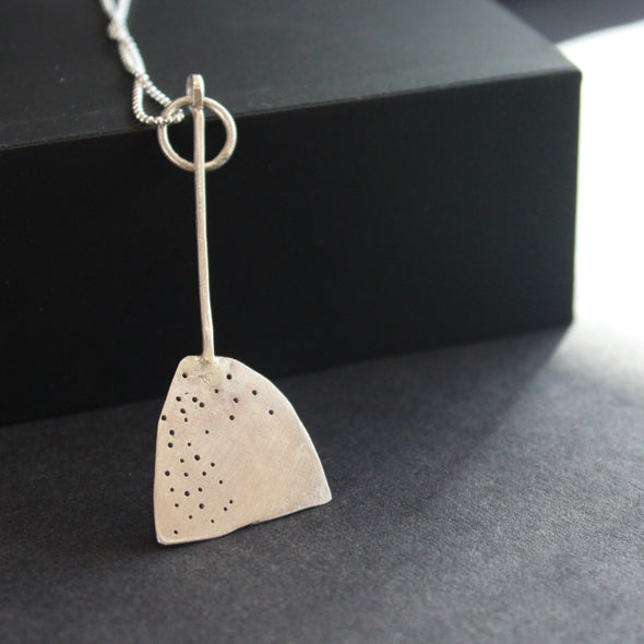 paddle shaped silver pendant on a silver chain by jeweller Lizzie Weir of Anatole Design.