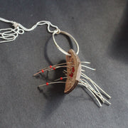 necklace of found objects wood pierced by metal strands by UK jeweller Lizzie Weir of Anatole Design.