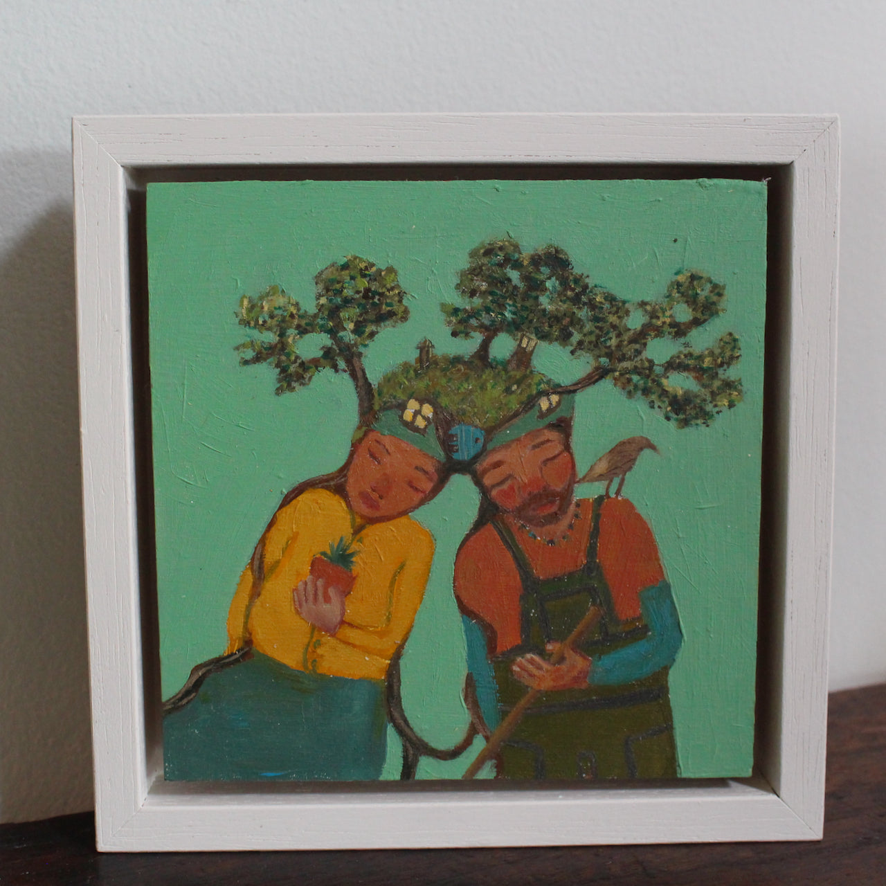 Siobhan Purdy, Cornish artist surreal painting of a couple  with a garden growing  on their  heads.