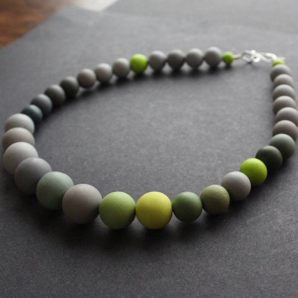 a green and grey bead necklace by Clare Lloyd 