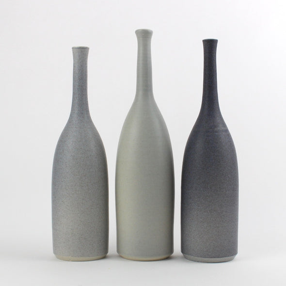 a trio of ceramic bottles in different shades of grey made by Lucy Burley 