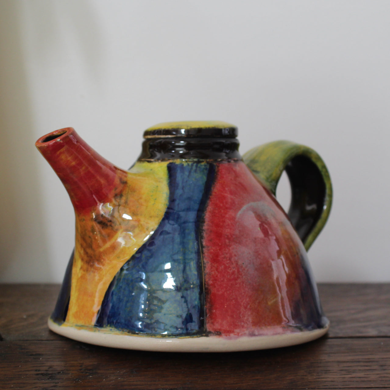 a brightly coloured ceramic tea pot by UK potter John Pollex.