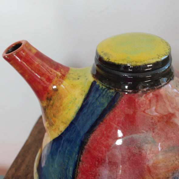 close up of a red and yellow spout on a brightly coloured ceramic tea pot by UK potter John Pollex