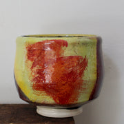yellow and red abstract ceramic tea bowl by UK potter John Pollex 