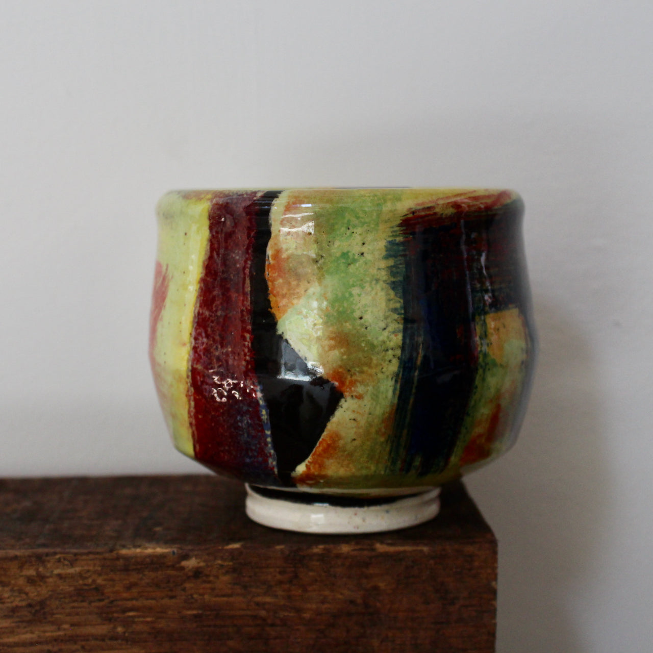 yellow and red abstract ceramic tea bowl by UK potter John Pollex.