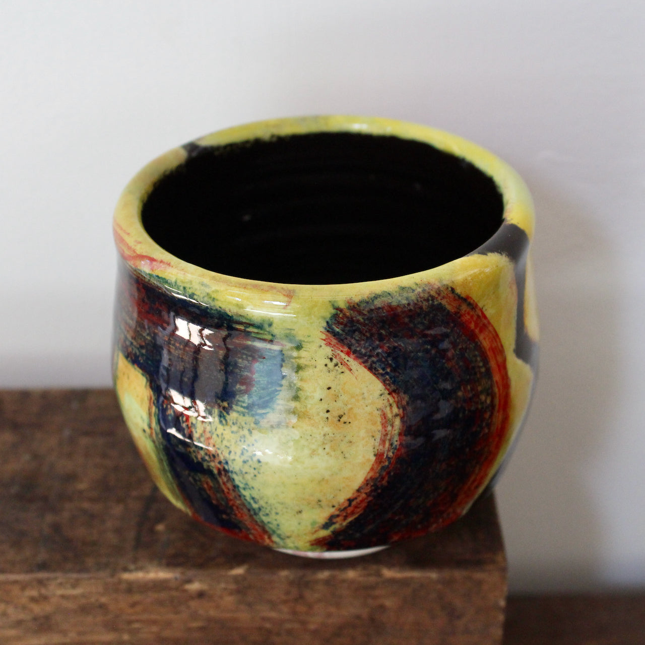 a yellow and red abstract ceramic tea bowl by celebrated UK potter John Pollex 