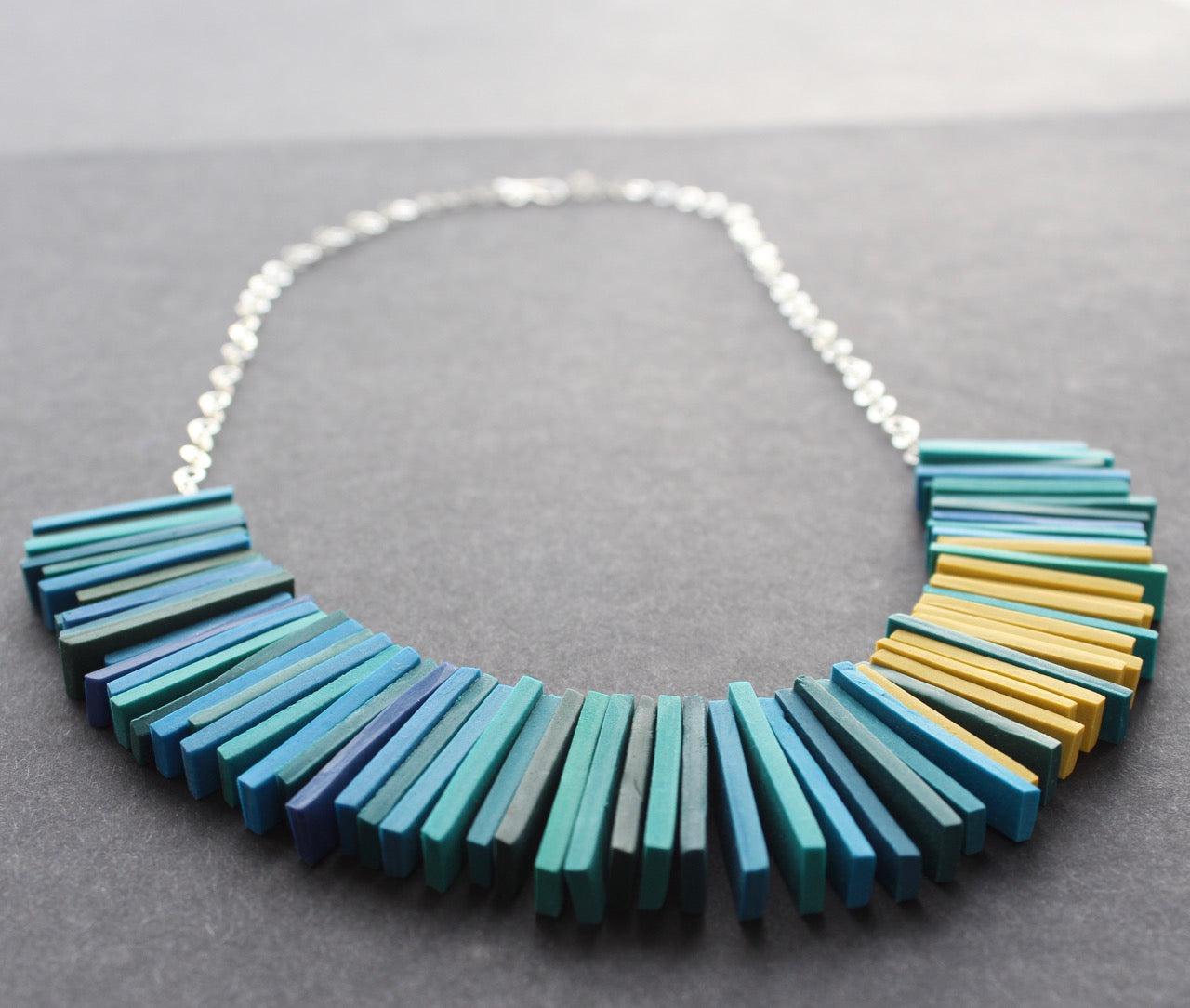 Modern deco necklace in teal blues and yellow by Clare Lloyd