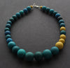 Graduated bead necklace with teal blues, greens and yellow by Clare Lloyd