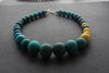Graduated bead necklace with teal blues, greens and yellow by Clare Lloyd 