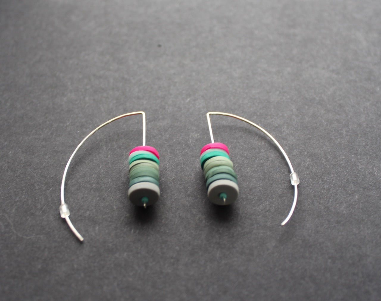 a pair of Clare Lloyd - stacked disc earrings in soft greens and cerise