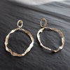 two hooped hand sculpted  sliver earrings by jewellery designer Claire Stockings-Baker