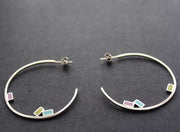 Abstract large rigid hoop earrings with small coloured squares by Clare Lloyd