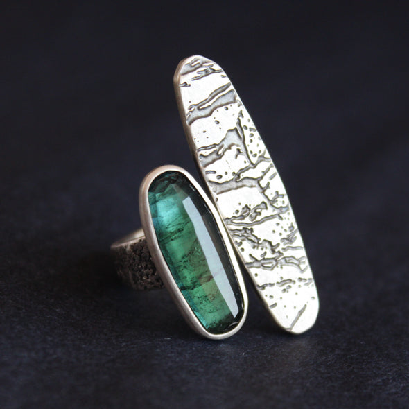 large ring by Cornwall jeweller Carin Lindberg with an oval shaped green stone and a larger silver lozenged shape