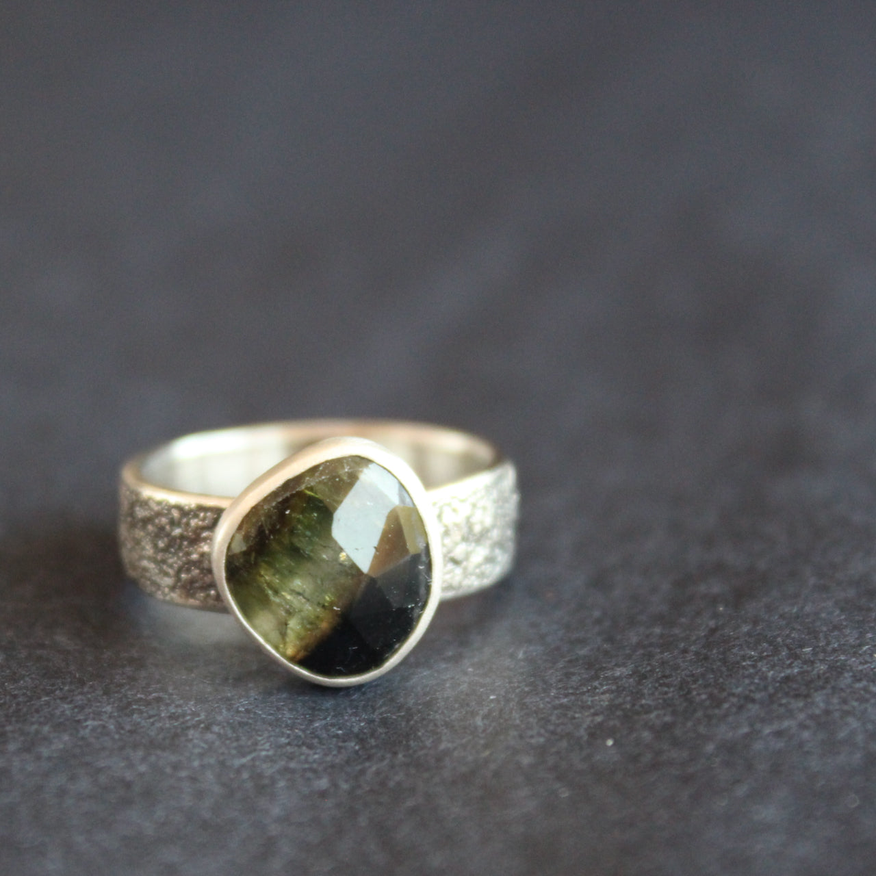 a textured silver ring with a dark green stone by UK jeweller Carin Lindberg 