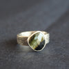 a textured silver ring with a dark green stone by Cornwall jeweller Carin Lindberg 