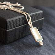 silver pendant with pale blue rectangular stone and round white diamond by Cornwall jewellery designer Carin Lindberg
