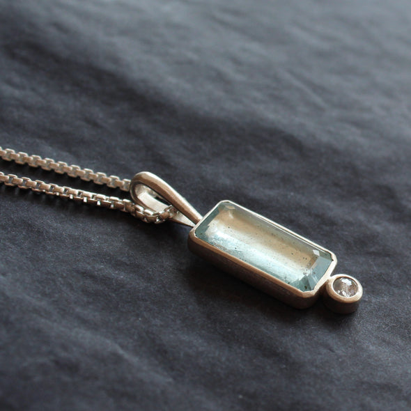 silver pendant with pale blue rectangular stone and round white diamond by UK jewellery designer Carin Lindberg.