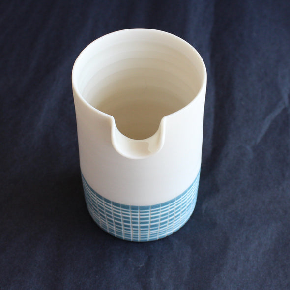 a porcelain pourer by Kathryn Sherriff of By the Line Pottery decorated with a blue cross hatch glaze 