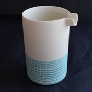 a ceramic pourer with a blue cross hatch design to the bottom half by Kathryn Sherriff of By the Line Pottery