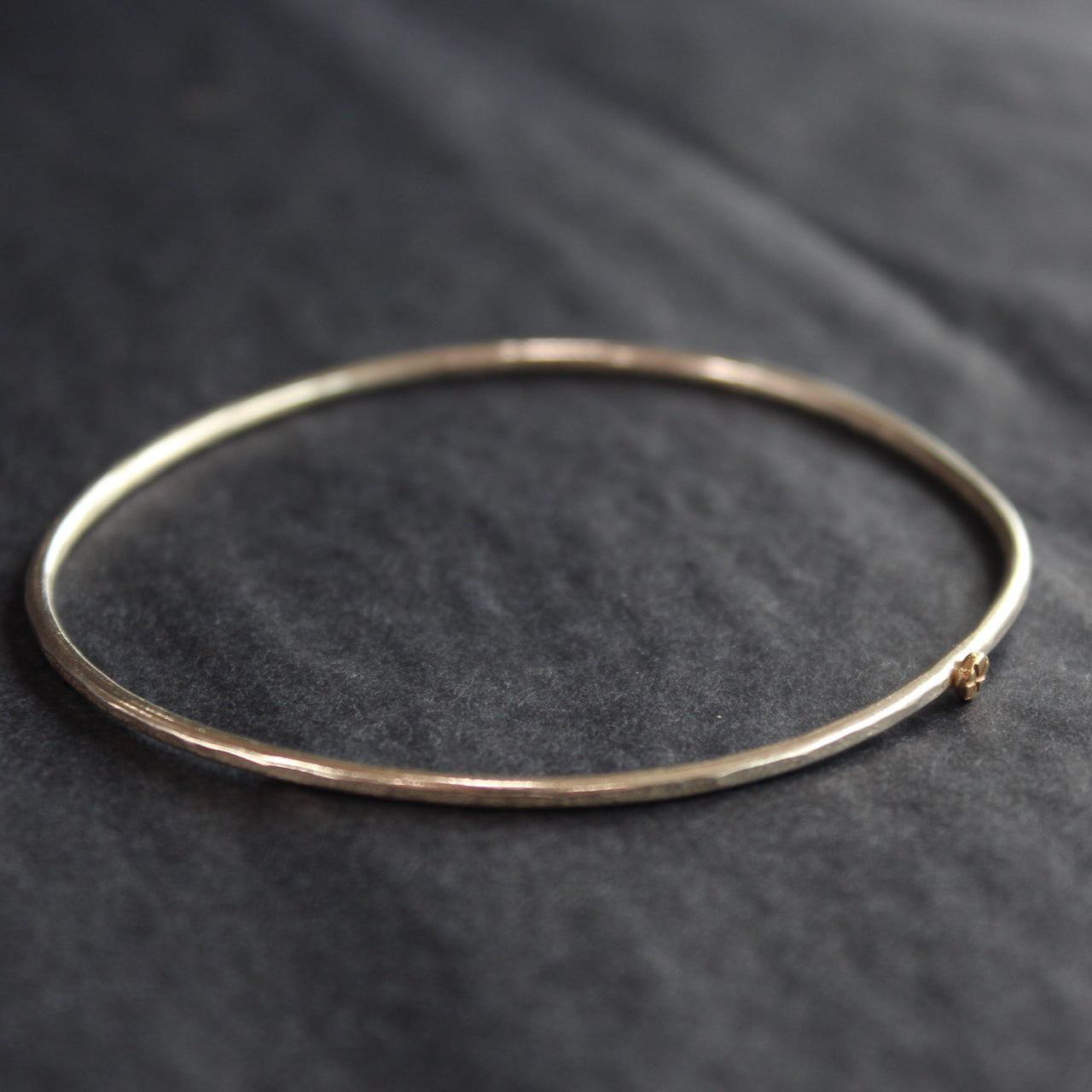 fine sliver bangle with small gold star by Cornwall jewellery designer Lucy Spink