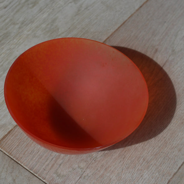 the interior of a orange glass bowl by Cornish glass artist Helen Eastham 