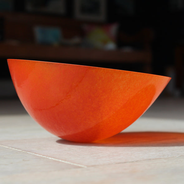 orange glass bowl with an angled top by Cornish glass artist Helen Eastham 