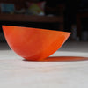 an orange glass bowl by Cornish glass artist Helen Eastham.