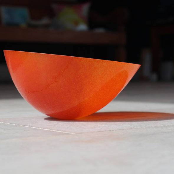 an orange glass bowl by Cornish glass artist Helen Eastham.