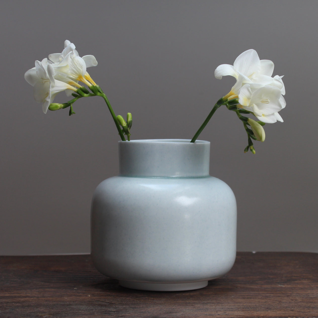 Pale Green ceramic vase by ceramicist Laura Plant with freesias 