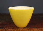 Tall yellow bowl Lucy Burley on a wooden table