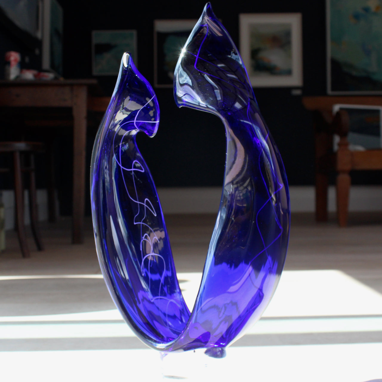 tall blue glass sculpture with white detail by glass artist Benjamin Lintell